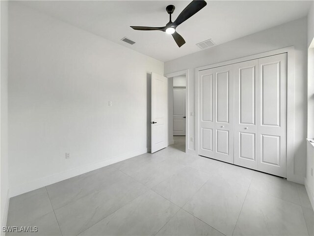 3247 72nd Ave NE, Naples, FL 34120 - unfurnished bedroom with a closet, a ceiling fan, and baseboards