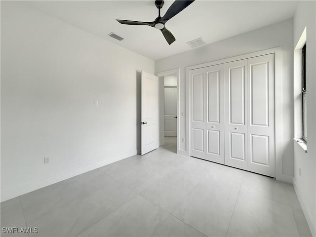 3247 72nd Ave NE, Naples, FL 34120 - unfurnished bedroom with a closet, baseboards, and ceiling fan