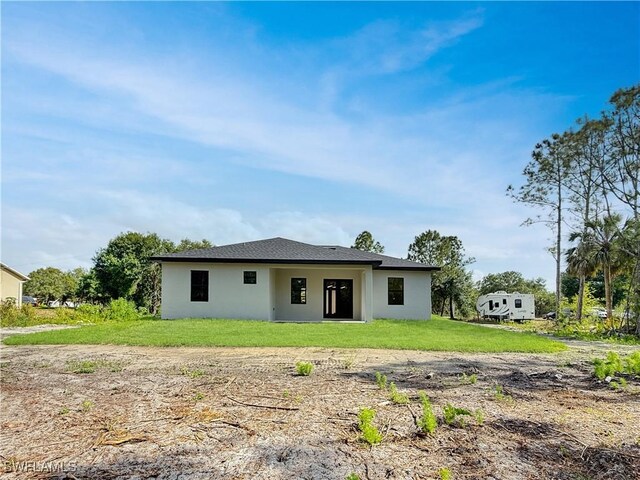 3247 72nd Ave NE, Naples, FL 34120 - rear view of house with stucco siding and a lawn