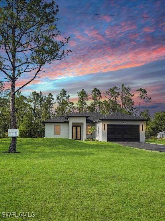 3247 72nd Ave NE, Naples, FL 34120 - view of front facade with driveway, a garage, a lawn, and stucco siding