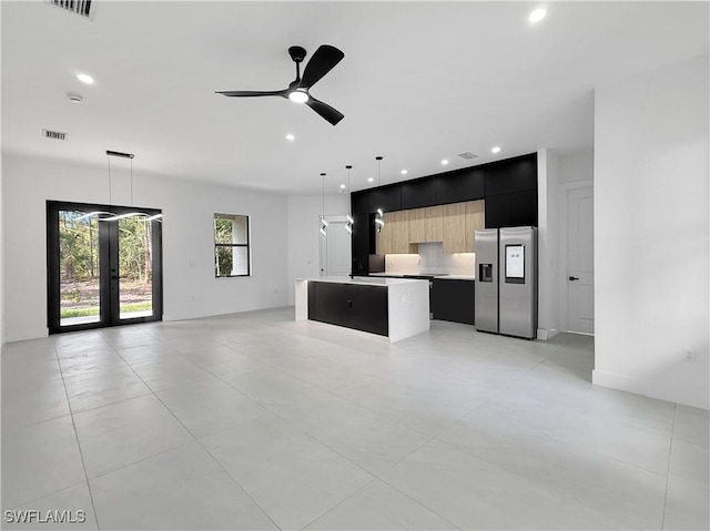 3247 72nd Ave NE, Naples, FL 34120 - unfurnished living room featuring french doors, recessed lighting, a ceiling fan, and a sink