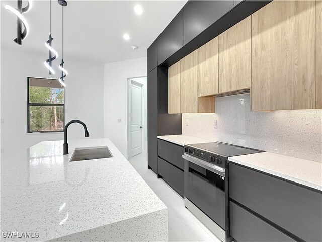 3247 72nd Ave NE, Naples, FL 34120 - kitchen featuring electric range oven, modern cabinets, a sink, light brown cabinets, and light stone countertops