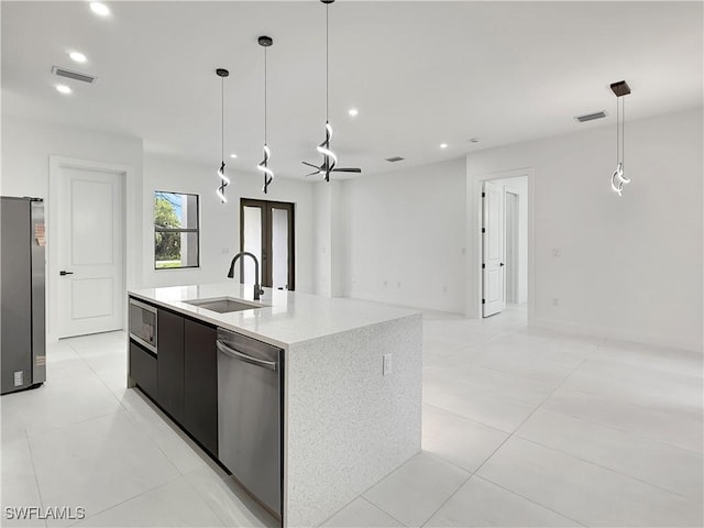 3247 72nd Ave NE, Naples, FL 34120 - kitchen with a sink, appliances with stainless steel finishes, recessed lighting, modern cabinets, and light tile patterned flooring