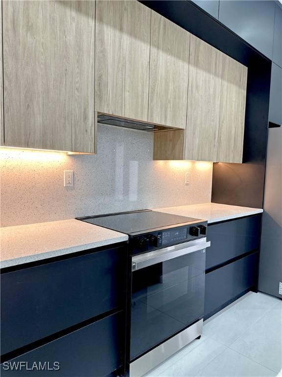 3247 72nd Ave NE, Naples, FL 34120 - kitchen featuring electric stove, modern cabinets, light countertops, and light tile patterned floors