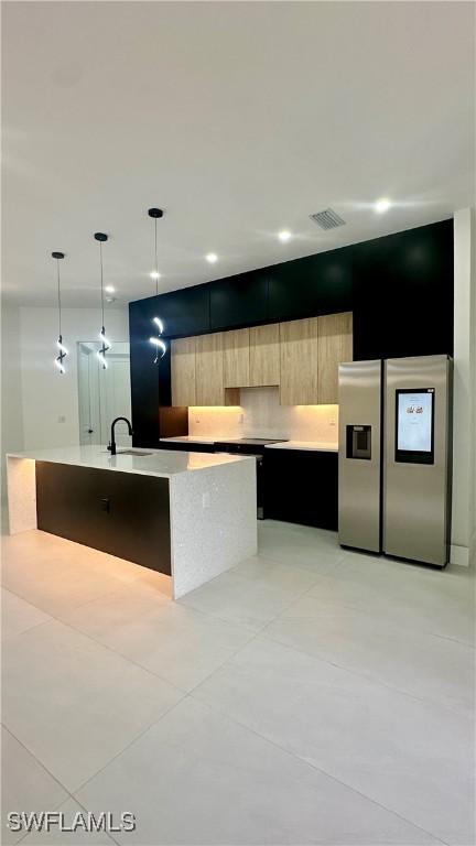 3247 72nd Ave NE, Naples, FL 34120 - kitchen featuring stainless steel fridge with ice dispenser, modern cabinets, light countertops, a sink, and light brown cabinetry