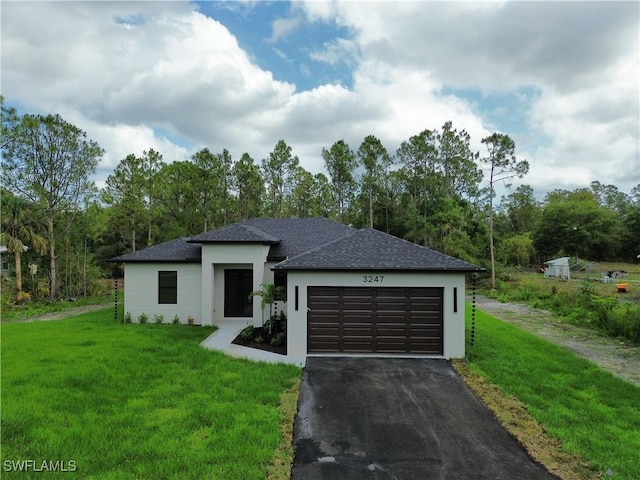 3247 72nd Ave NE, Naples, FL 34120 - prairie-style home with asphalt driveway, a shingled roof, a front yard, and stucco siding
