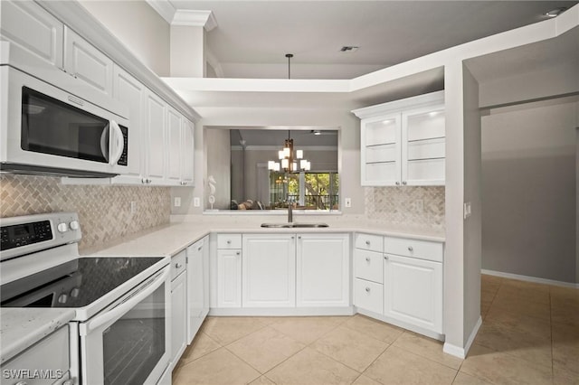 1771 Bermuda Greens Blvd Unit O4, Naples, FL 34110 - kitchen featuring white microwave, range with electric cooktop, a sink, a chandelier, and light tile patterned floors