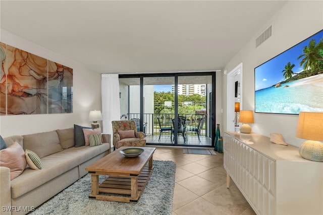 741 S Collier Blvd Unit 302, Marco Island, FL 34145 - living room featuring light tile patterned floors and expansive windows