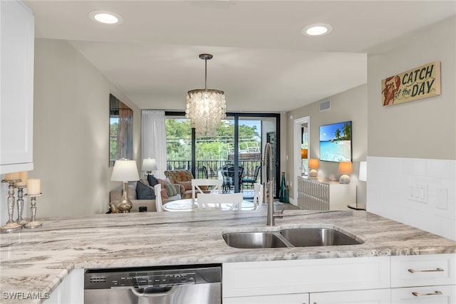 741 S Collier Blvd Unit 302, Marco Island, FL 34145 - kitchen featuring dishwasher, a sink, light stone counters, white cabinetry, and a chandelier