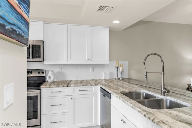 741 S Collier Blvd Unit 302, Marco Island, FL 34145 - kitchen featuring appliances with stainless steel finishes, a sink, backsplash, light stone countertops, and recessed lighting
