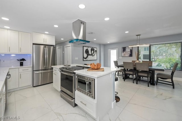 52 Fairview Blvd, Fort Myers Beach, FL 33931 - kitchen featuring appliances with stainless steel finishes, wall chimney exhaust hood, light marble finish floors, a center island, and white cabinetry