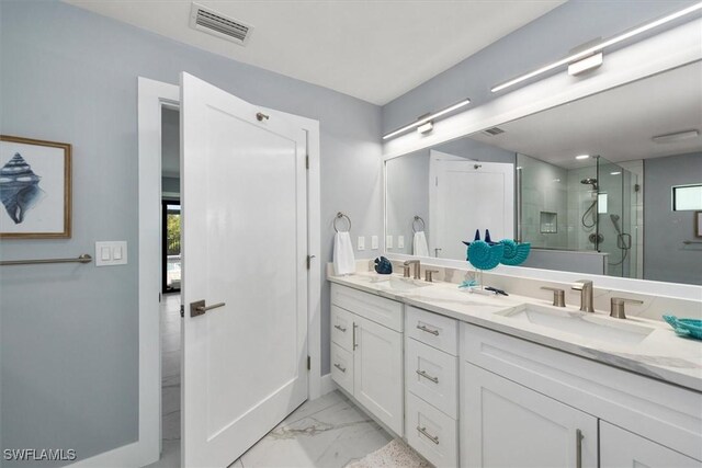 52 Fairview Blvd, Fort Myers Beach, FL 33931 - full bathroom featuring double vanity, a shower stall, marble look tile flooring, and baseboards