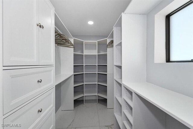 52 Fairview Blvd, Fort Myers Beach, FL 33931 - walk in closet featuring light marble finish floors