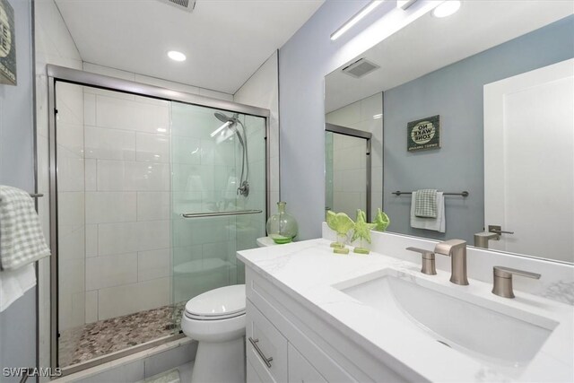 52 Fairview Blvd, Fort Myers Beach, FL 33931 - bathroom with vanity, toilet, a shower stall, and recessed lighting