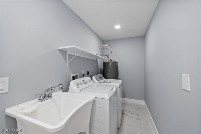 52 Fairview Blvd, Fort Myers Beach, FL 33931 - laundry area with light marble finish flooring, water heater, washer and clothes dryer, baseboards, and recessed lighting