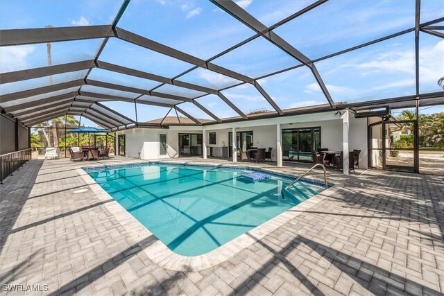 52 Fairview Blvd, Fort Myers Beach, FL 33931 - outdoor pool featuring outdoor dining area, a patio area, and glass enclosure