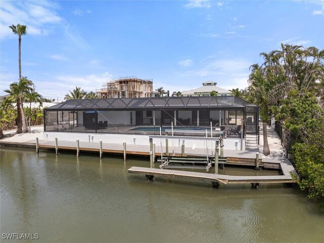52 Fairview Blvd, Fort Myers Beach, FL 33931 - back of house with an outdoor pool, a water view, and a lanai