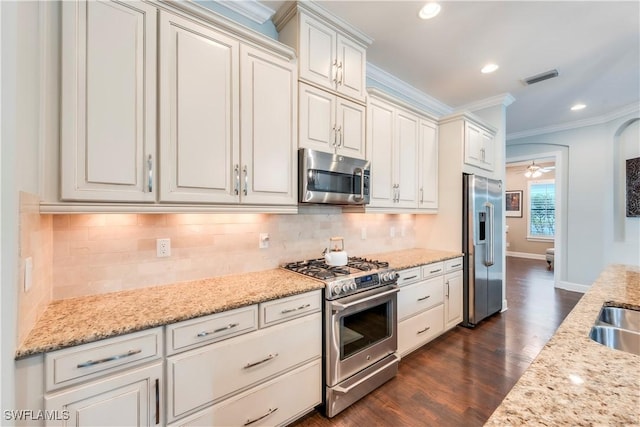 23778 Pebble Pointe Ln, Estero, FL 34135 - kitchen with stainless steel appliances, ornamental molding, dark wood-style floors, decorative backsplash, and recessed lighting