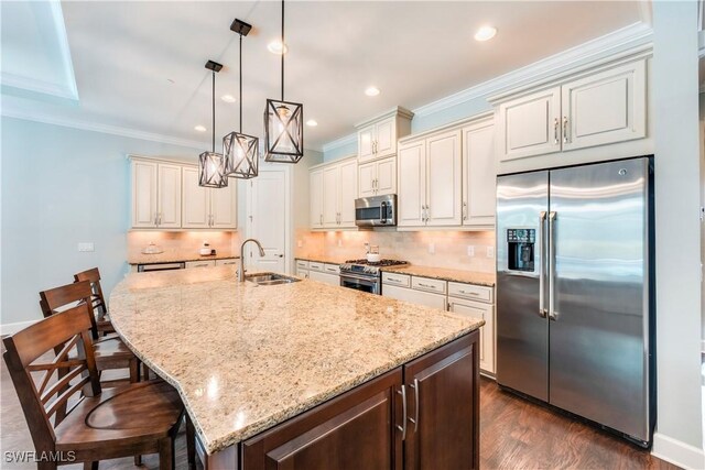 23778 Pebble Pointe Ln, Estero, FL 34135 - kitchen featuring stainless steel appliances, a sink, crown molding, light stone counters, and decorative backsplash