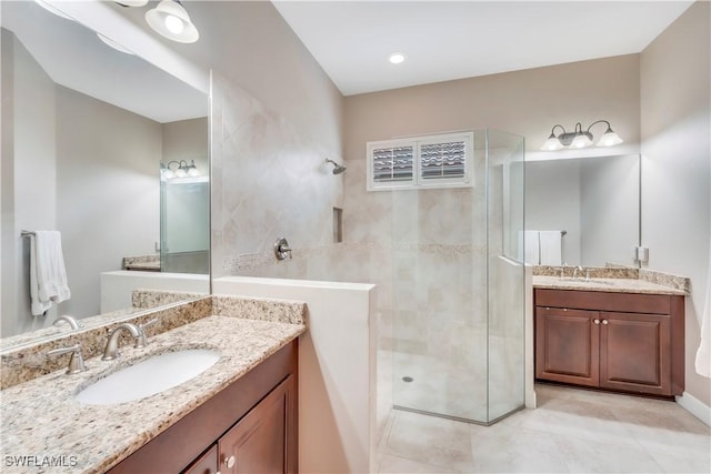 23778 Pebble Pointe Ln, Estero, FL 34135 - full bath with a tile shower, two vanities, and tile patterned floors