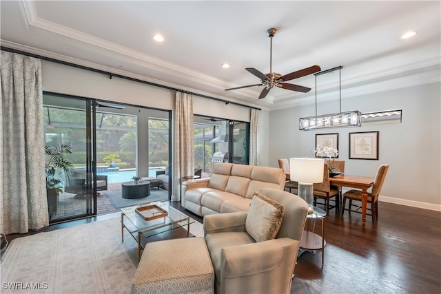 23778 Pebble Pointe Ln, Estero, FL 34135 - living room featuring a raised ceiling, ornamental molding, a ceiling fan, recessed lighting, and wood finished floors