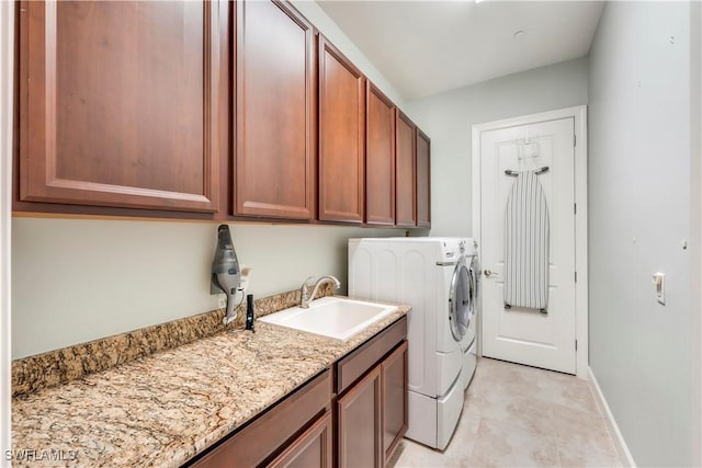 23778 Pebble Pointe Ln, Estero, FL 34135 - laundry room featuring washing machine and clothes dryer, cabinet space, and baseboards