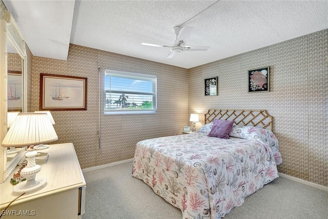 1206 Edington Pl Unit D304, Marco Island, FL 34145 - bedroom featuring wallpapered walls, baseboards, carpet floors, a textured ceiling, and a ceiling fan