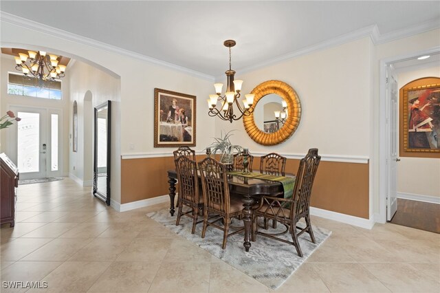 11107 Sparkleberry Dr, Fort Myers, FL 33913 - dining room featuring a chandelier, arched walkways, crown molding, light tile patterned floors, and baseboards