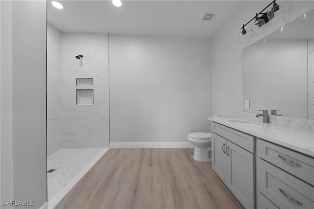 4201 17th St SW, Lehigh Acres, FL 33976 - full bathroom featuring a tile shower, vanity, wood finished floors, and recessed lighting