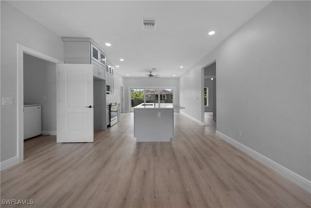 4201 17th St SW, Lehigh Acres, FL 33976 - unfurnished living room with ceiling fan, recessed lighting, light wood-style floors, and washer / dryer