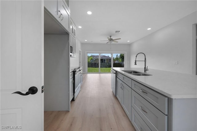 4201 17th St SW, Lehigh Acres, FL 33976 - kitchen with stainless steel appliances, gray cabinets, light wood finished floors, ceiling fan, and recessed lighting