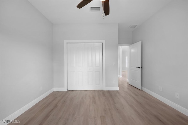 4201 17th St SW, Lehigh Acres, FL 33976 - unfurnished bedroom with light wood-style flooring, a closet, and a ceiling fan