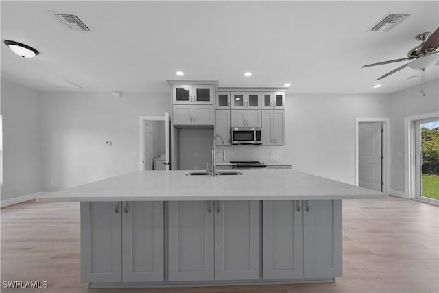 4201 17th St SW, Lehigh Acres, FL 33976 - kitchen with appliances with stainless steel finishes, gray cabinetry, a ceiling fan, a kitchen island with sink, and recessed lighting