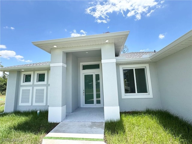 1009 Euclid Ave, Lehigh Acres, FL 33972 - entrance to property with stucco siding and roof with shingles
