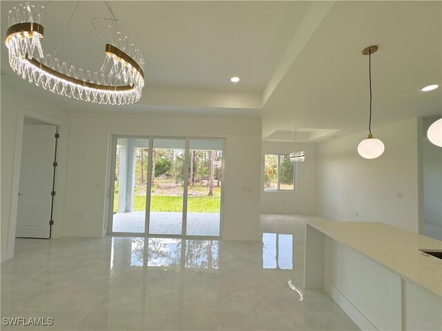 1009 Euclid Ave, Lehigh Acres, FL 33972 - unfurnished dining area with recessed lighting, a tray ceiling, and a chandelier