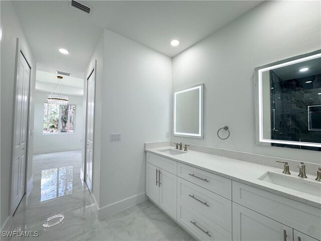 1009 Euclid Ave, Lehigh Acres, FL 33972 - full bathroom featuring marble look tiles, baseboards, double vanity, a chandelier, and recessed lighting