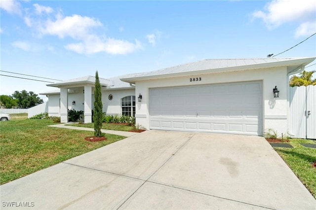 2833 NW 4th Ave, Cape Coral, FL 33993 - single story home with concrete driveway, stucco siding, a front lawn, and an attached garage