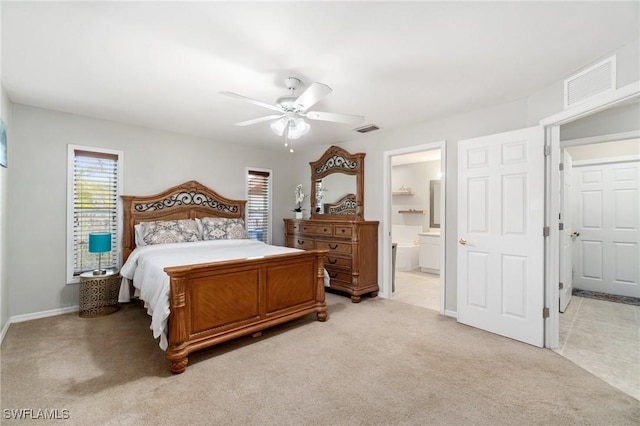 2833 NW 4th Ave, Cape Coral, FL 33993 - bedroom featuring light carpet, baseboards, a ceiling fan, and connected bathroom