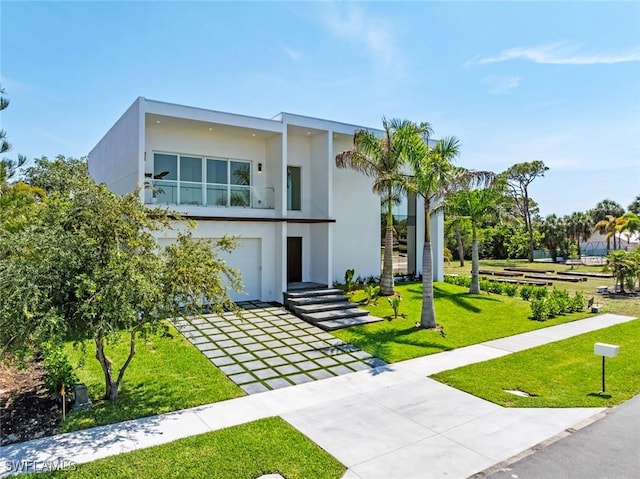 1135 Bluebird Ave, Marco Island, FL 34145 - view of front facade with stucco siding, stairs, a front lawn, concrete driveway, and a garage
