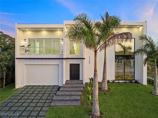 1135 Bluebird Ave, Marco Island, FL 34145 - contemporary house with a balcony, stucco siding, a front lawn, and driveway