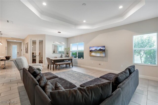 7028 Mistral Way, Fort Myers, FL 33966 - living room with a raised ceiling, ornamental molding, recessed lighting, baseboards, and light tile patterned flooring