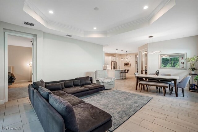 7028 Mistral Way, Fort Myers, FL 33966 - living area featuring a tray ceiling, recessed lighting, ornamental molding, light tile patterned floors, and baseboards