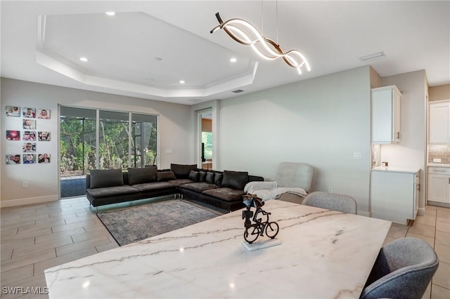 7028 Mistral Way, Fort Myers, FL 33966 - living room featuring recessed lighting, a tray ceiling, and baseboards