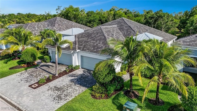 7028 Mistral Way, Fort Myers, FL 33966 - view of front of house featuring an attached garage and decorative driveway