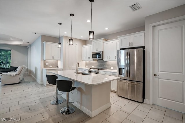 7028 Mistral Way, Fort Myers, FL 33966 - kitchen featuring stainless steel appliances, a sink, decorative backsplash, recessed lighting, and white cabinetry