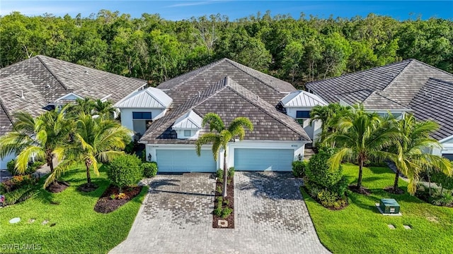 7028 Mistral Way, Fort Myers, FL 33966 - view of front of home featuring driveway, stucco siding, a garage, and a front lawn