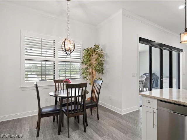 836 14th St SE, Naples, FL 34117 - dining room with light wood finished floors, baseboards, a chandelier, and crown molding