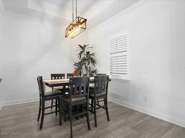 836 14th St SE, Naples, FL 34117 - dining room featuring wood finished floors, crown molding, a chandelier, and baseboards