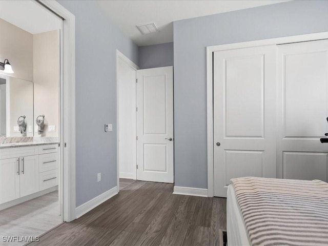 836 14th St SE, Naples, FL 34117 - bedroom featuring wood finished floors, baseboards, a closet, and a sink