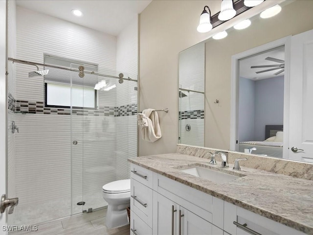 836 14th St SE, Naples, FL 34117 - bathroom with a stall shower, vanity, toilet, connected bathroom, and wood finished floors